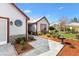 Inviting front yard features stone walkway, mature landscaping, and a delightful water fountain feature at 1914 Antonia Pl, The Villages, FL 32159