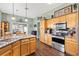 Kitchen with stainless steel appliances, wood cabinets, and granite countertops at 1914 Antonia Pl, The Villages, FL 32159