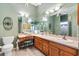 Bright main bathroom with a large mirror, double sinks, and a vanity area at 1914 Antonia Pl, The Villages, FL 32159