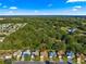 Aerial view of homes, highlighting proximity to a nature preserve at 2010 Harston Trl, The Villages, FL 32162