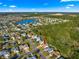 Aerial view of a residential area with houses, a lake, and a green field at 2010 Harston Trl, The Villages, FL 32162