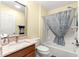 Cozy bathroom with a tub and shower combination, single vanity, and marble countertops at 2010 Harston Trl, The Villages, FL 32162