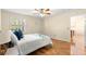 Well-lit bedroom with hardwood flooring, a ceiling fan, and large window, perfect for a serene retreat at 2010 Harston Trl, The Villages, FL 32162