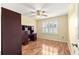 Bedroom featuring hardwood floors, a ceiling fan, a desk, and a window for natural light at 2010 Harston Trl, The Villages, FL 32162