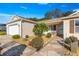 Charming front entrance with a walkway, palm tree, and well-manicured landscaping at 2010 Harston Trl, The Villages, FL 32162