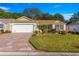 Well-maintained home with a two-car garage, lovely lawn, and tasteful landscaping at 2010 Harston Trl, The Villages, FL 32162