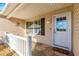 Inviting front porch area with decorative touches and a welcoming entrance door at 2010 Harston Trl, The Villages, FL 32162