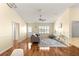 Bright living room features wood floors, plantation shutters, and a comfortable seating area at 2010 Harston Trl, The Villages, FL 32162