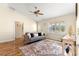 Cozy living room with wood floors and a comfortable sofa features a sun-filled window at 2010 Harston Trl, The Villages, FL 32162