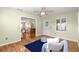 Light and airy sitting room featuring hardwood floors, large windows and doorway to the dining area at 2010 Harston Trl, The Villages, FL 32162