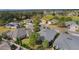 An aerial view showcases the community and its beautiful homes, lush landscaping, and water features at 2022 Abordale Ln, The Villages, FL 32162