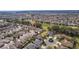 Wide aerial shot showing a residential community featuring well-maintained homes, golf course, and numerous trees at 2022 Abordale Ln, The Villages, FL 32162