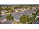 Elevated view captures the roofs of multiple residences within a community, complemented by palm trees at 2022 Abordale Ln, The Villages, FL 32162