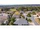 Expansive aerial view of homes in a neighborhood with lush landscaping and a glimpse of a golf course at 2022 Abordale Ln, The Villages, FL 32162