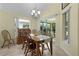 Cozy dining room features chandelier lighting and sliding door to patio at 2022 Abordale Ln, The Villages, FL 32162