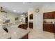 Kitchen with granite countertops, stainless appliances, and seamless flow to the living room at 2022 Abordale Ln, The Villages, FL 32162