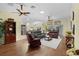 Spacious living room featuring hardwood floors, ceiling fans, and an open floor plan at 2022 Abordale Ln, The Villages, FL 32162