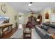 Bright living room with hardwood floors, ceiling fan, and an open view to the entrance at 2022 Abordale Ln, The Villages, FL 32162