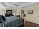 Large main bedroom featuring tray ceilings, a ceiling fan and hardwood floors at 2022 Abordale Ln, The Villages, FL 32162