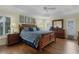 Main bedroom with decorative tray ceiling, wood floors, and large windows at 2022 Abordale Ln, The Villages, FL 32162