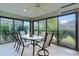 Sunroom with tiled floor, ceiling fan, and glass walls offering lots of natural light at 2022 Abordale Ln, The Villages, FL 32162