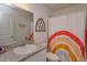 Well-lit bathroom featuring a single vanity with granite countertop and shower with rainbow curtain at 2024 Hemingway Cir, Groveland, FL 34736