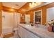 Warm-toned bathroom featuring a spacious vanity with a view into walk-in closet at 2024 Hemingway Cir, Groveland, FL 34736