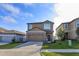 Charming two-story home with stone accents and a well-manicured lawn at 2024 Hemingway Cir, Groveland, FL 34736