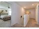 Hallway leading to a bedroom, showcasing neutral tones and natural light at 2024 Hemingway Cir, Groveland, FL 34736