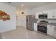 Well-lit kitchen with stainless steel appliances and ample counter space at 2024 Hemingway Cir, Groveland, FL 34736