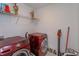 Laundry room featuring modern, red washer and dryer units, plus shelving for storage at 2024 Hemingway Cir, Groveland, FL 34736