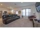 Spacious living room with kitchen view, featuring a comfortable sofa and decorative accents at 2024 Hemingway Cir, Groveland, FL 34736