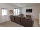 Inviting living room with a comfortable sofa, television, and natural light from the windows at 2024 Hemingway Cir, Groveland, FL 34736