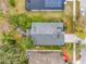 A bird's-eye view of a well-maintained home, featuring a fire pit, complemented by lush landscaping and surrounded by neighbors at 235 Pima Trl, Groveland, FL 34736