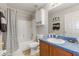 Bathroom with a vanity and shower over bath, featuring patterned shower curtain at 235 Pima Trl, Groveland, FL 34736