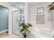 Bright bathroom featuring a soaking tub, glass shower, and a decorative plant at 235 Pima Trl, Groveland, FL 34736