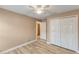 Empty bedroom with a ceiling fan, wood-look floors, and ample closet space at 235 Pima Trl, Groveland, FL 34736