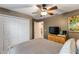 Bedroom with a ceiling fan, closet, and television on a wooden dresser at 235 Pima Trl, Groveland, FL 34736