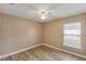 Well-lit empty bedroom with wood-look flooring and a bright window at 235 Pima Trl, Groveland, FL 34736