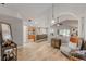 Spacious living room featuring light grey walls, wood floors, and an open layout connecting to the kitchen at 235 Pima Trl, Groveland, FL 34736