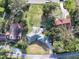 Overhead view of the property highlighting the house layout and its setting amongst mature trees at 2422 Topping Pl, Eustis, FL 32726