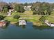 Aerial view of lake with multiple docks, lifts, and homes at 2422 Topping Pl, Eustis, FL 32726