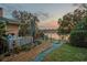 Backyard patio with rock and grass area, seating and a lake view at 2422 Topping Pl, Eustis, FL 32726