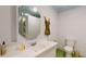 Bathroom with green floor and white walls and fixtures, including a large mirror and vintage fixtures at 2422 Topping Pl, Eustis, FL 32726