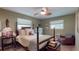 Cozy bedroom features a four-poster bed, ceiling fan, and neutral decor at 2422 Topping Pl, Eustis, FL 32726