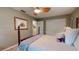 Comfortable bedroom with a four-poster bed, ceiling fan, and ample closet space at 2422 Topping Pl, Eustis, FL 32726