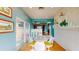 Bright dining room with a view of the kitchen and patio, featuring a white table and chairs at 2422 Topping Pl, Eustis, FL 32726