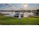 Lakeside view of a dock with boat lift on a clear day at 2422 Topping Pl, Eustis, FL 32726