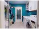 Bright laundry room features painted walls and white appliances at 2422 Topping Pl, Eustis, FL 32726