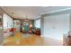 Bright living room featuring hardwood floors, large double doors, and stylish mid-century modern furnishings at 2422 Topping Pl, Eustis, FL 32726